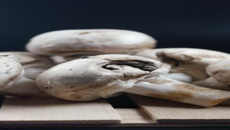 close up of fresh white mushrooms on wooden surface