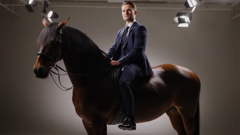 a man in a suit riding a horse in a studio setting