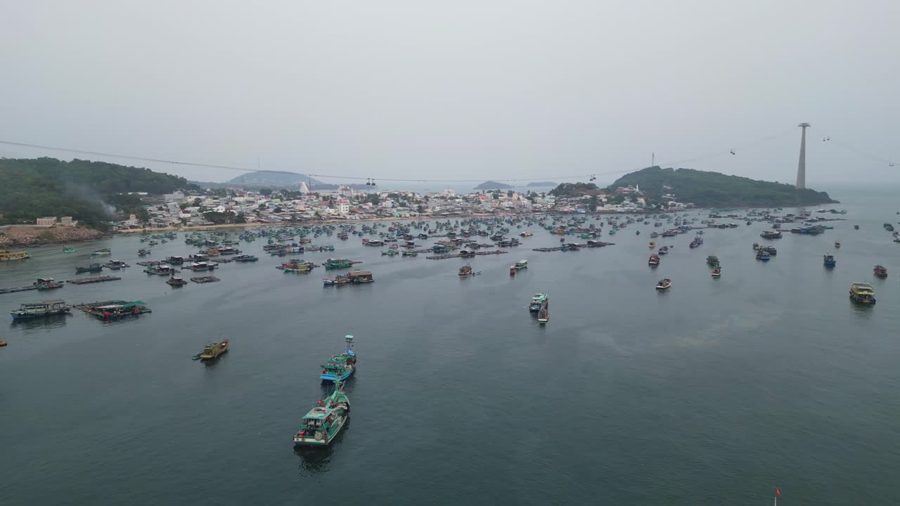 Fishing Boats In The Sea Near The Phu Quoc Harbor Overlooking The Cable Cars At Sunset In Vietnam. - aerial shot