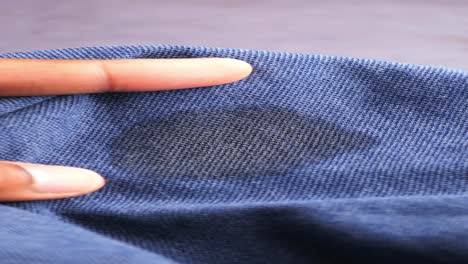 closeup of a dirty stain on a blue polo shirt