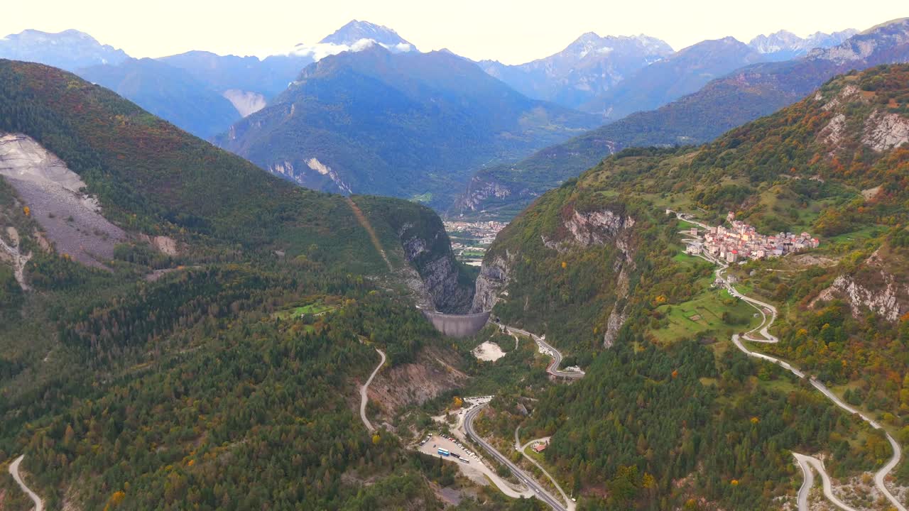 Aerial View of a Mountain Valley with a Dam and Winding Roads