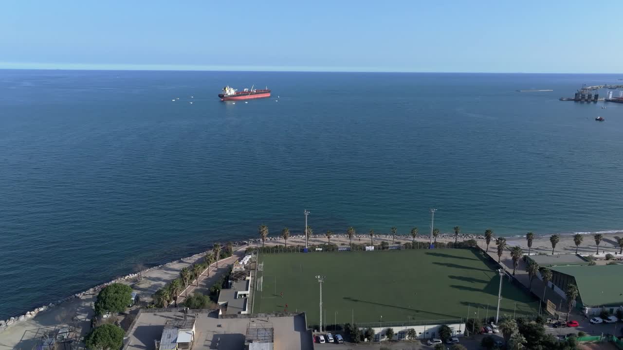 Coastal football field by the sea in Savona Zinola, sunny and peaceful setting