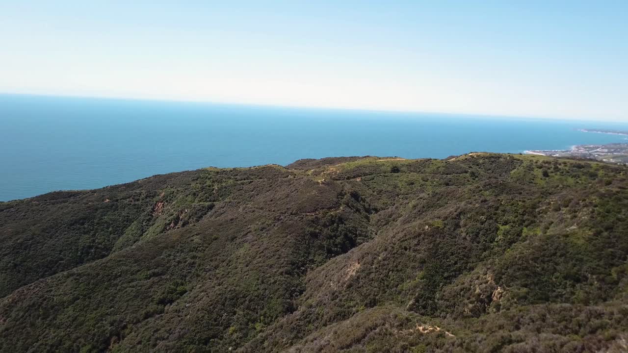 Beautiful panning Aerial View with drone of Malibu and Santa Monica Mountains in Los Angeles, California on a sunny day