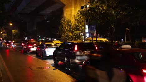 vehicles moving under an overpass at night