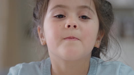 portrait beautiful little girl smiling looking at camera cute child with playful expression running hand through hair enjoying happy childhood 4k