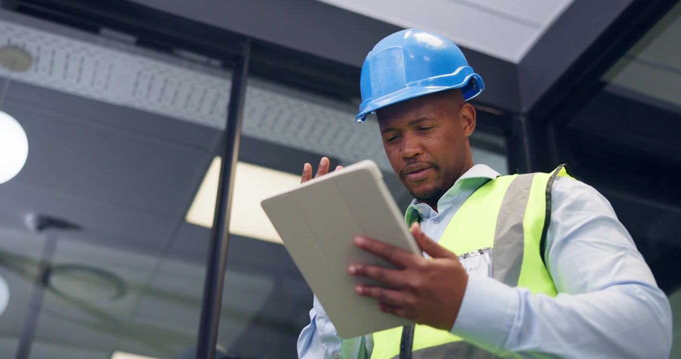 Construction Manager Using Digital Tablet on Site