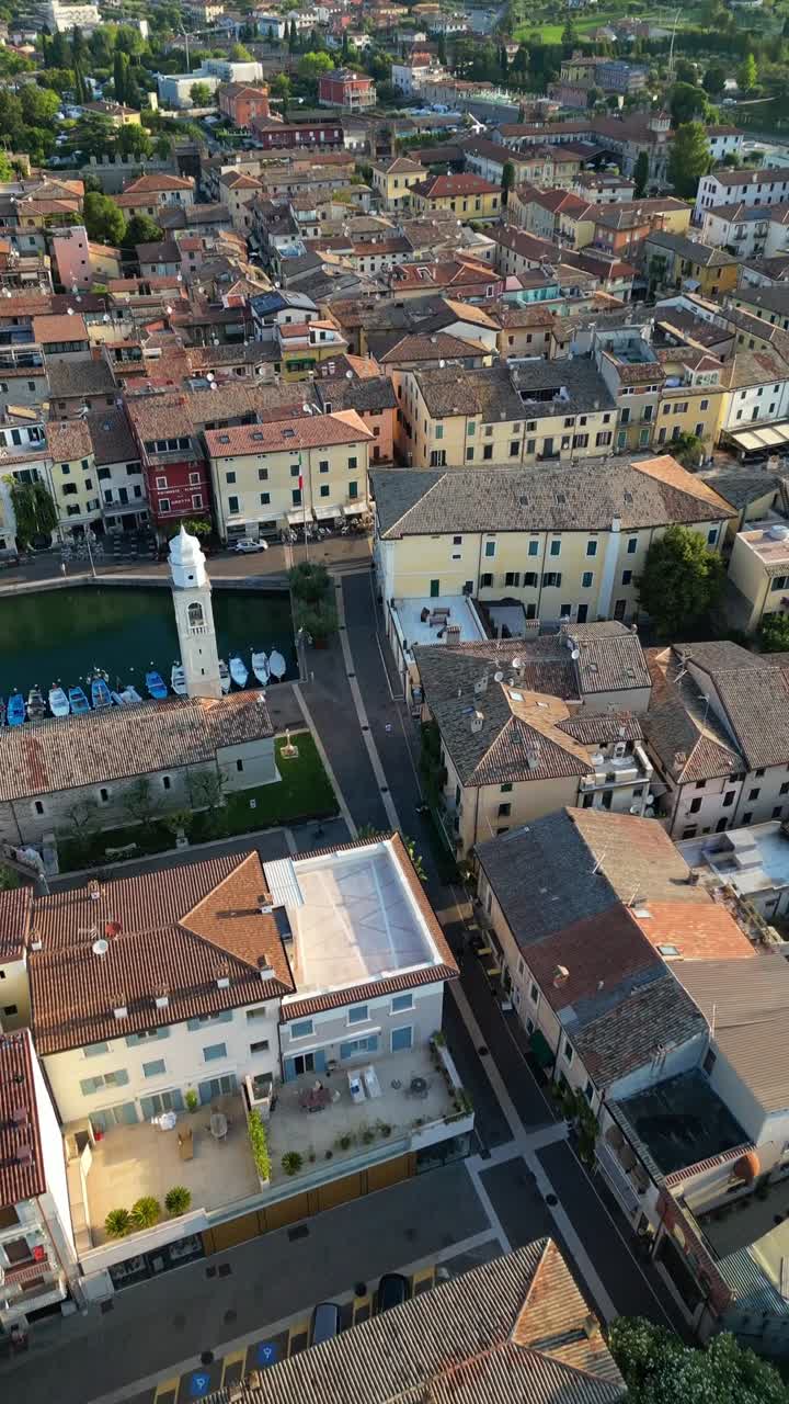Lazise historic charming medieval walled town in Italy, aerial drone over old port