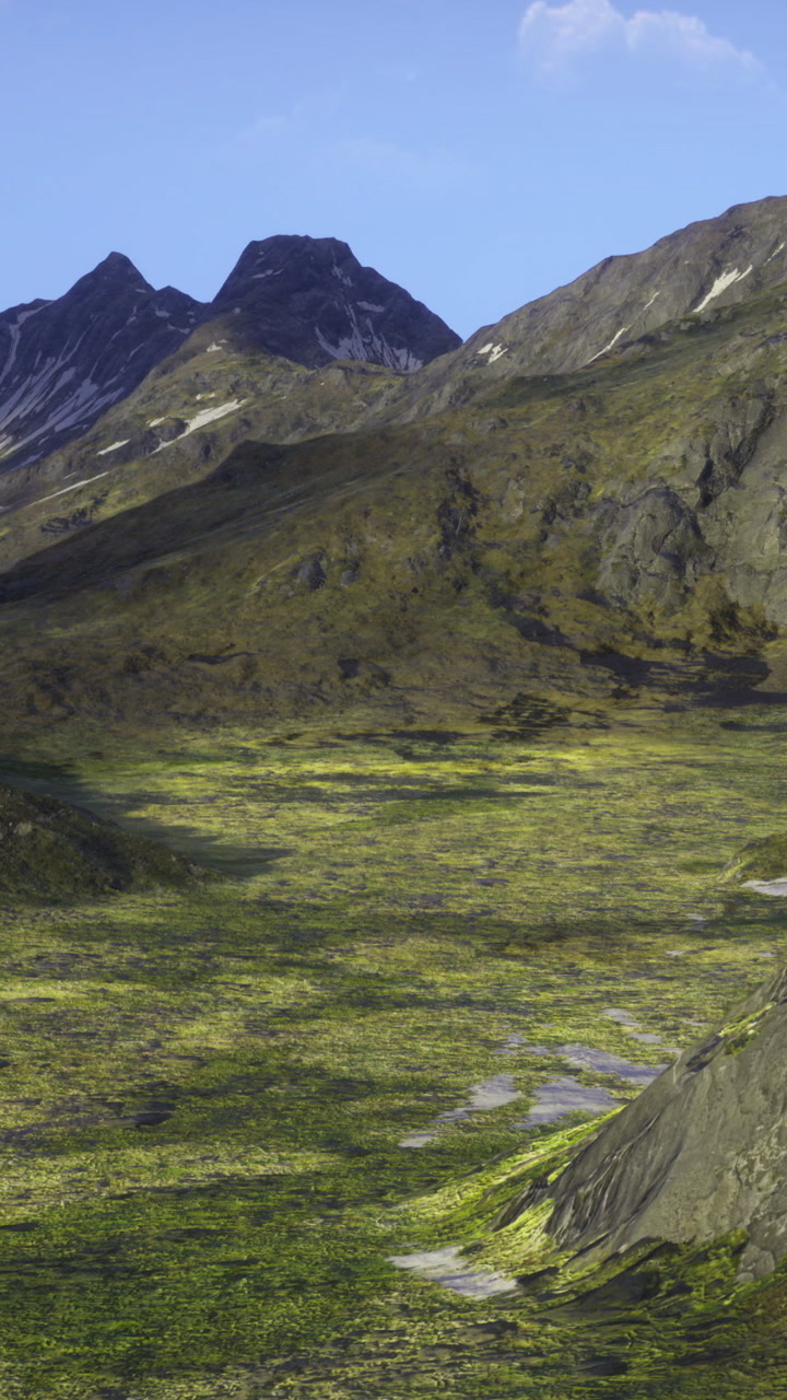 Majestic green valley surrounded by rugged mountains at dawn