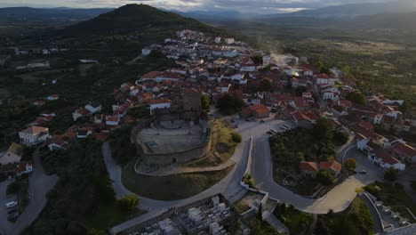 Drone-flies-then-tilts-over-the-Belmonte-Castle-and-surrounding-village-with-brick-tiles