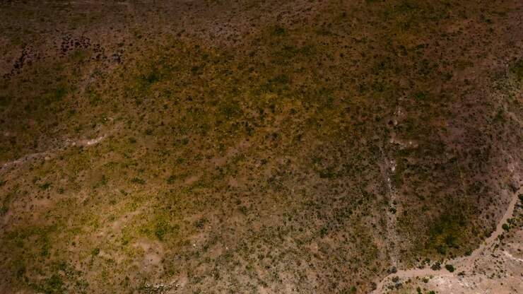 Aerial Drone Shots pans from the desert floor to the Red Rock Canyon mountains during the day time in Las Vegas, NV