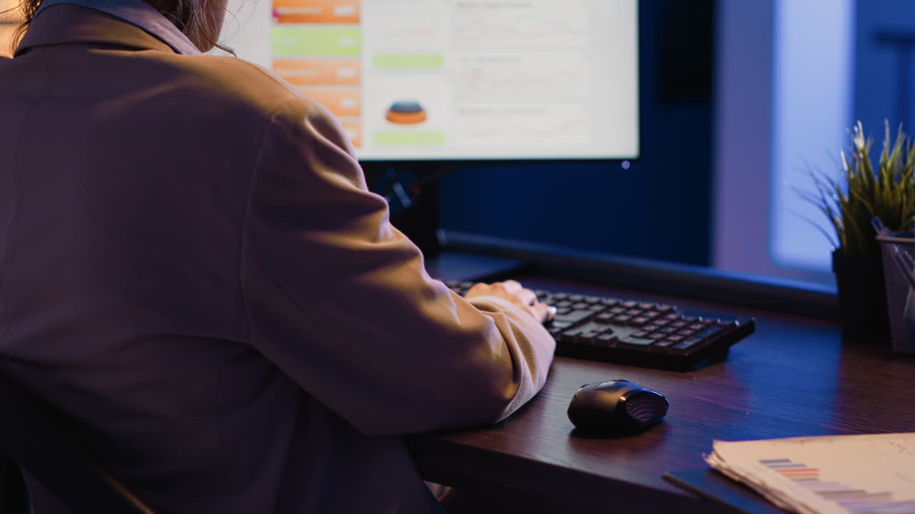 Businesswoman working on computer with charts