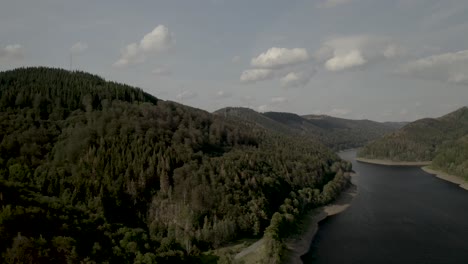 Scenic-Drone-Shot-of-a-beautiful-lake-at-sunset-in-the-Harz-National-Park,-Germany,-Europe