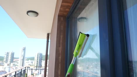 window cleaning on balcony with city view