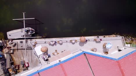 establishment aerial drone shot of a sunny restaurant with outlook overview to the sea, cute shore bistro in the sun, ocean side