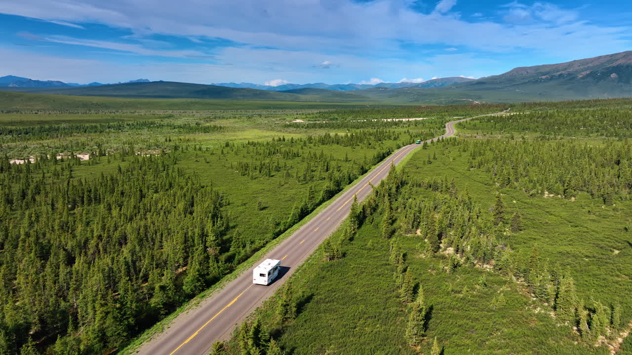 Scenic drive through Alaska wilderness. Stunning views of lush landscapes on a winding Alaskan road, ideal for adventurous nature lovers