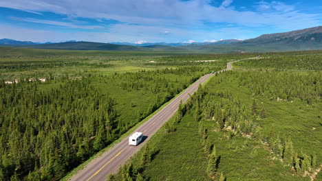 scenic drive through alaska wilderness. stunning views of lush landscapes on a winding alaskan road, ideal for adventurous nature lovers