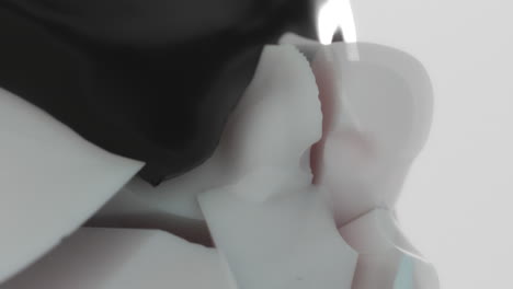 a black liquid metal flows slowly on the sculpture