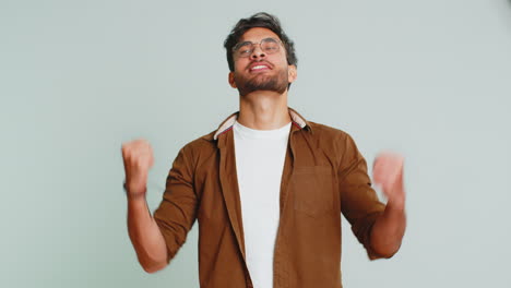 happy indian man celebrating success, winning, birthday, lottery jackpot goal achievement, good news