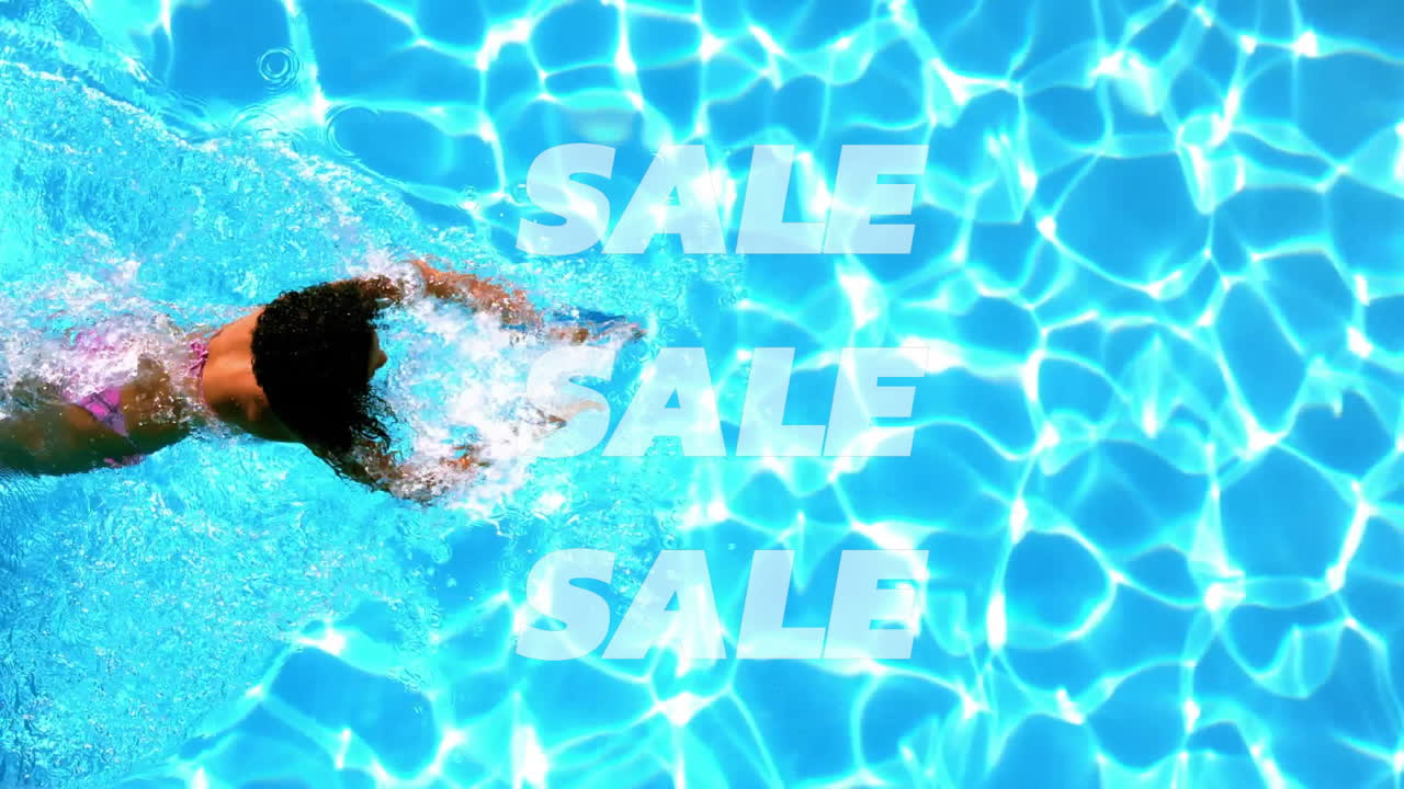 In pool, swimmer surrounded by animation of repeated SALE text over water