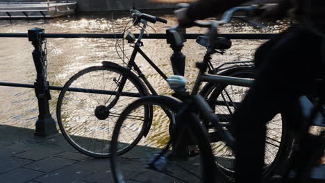 the bicycle by canal railings amsterdam