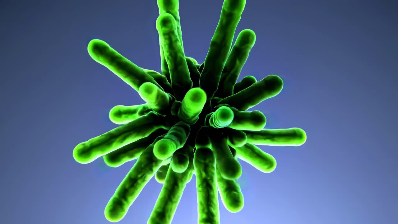 3D-rendered green virus model viewed from below against a blue gradient background