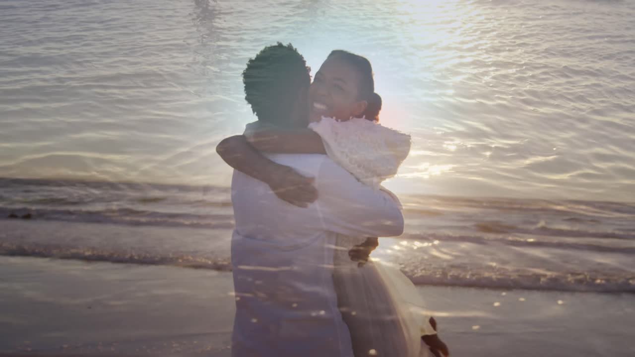 Animation of sea over married african american couple at beach