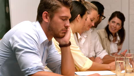 casual businessman falling asleep during meeting