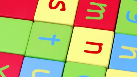 high view of colorful alphabet toy blocks turning