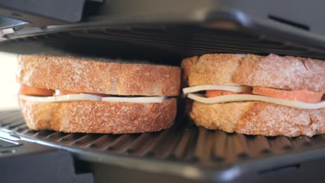 grilled cheese sandwiches being cooked in a panini press