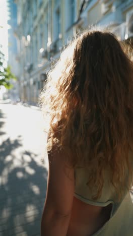 woman with curly hair on city street