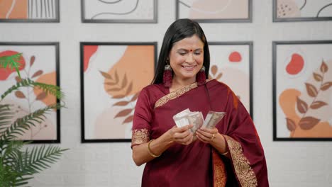 Indian-mother-counting-money-with-happiness