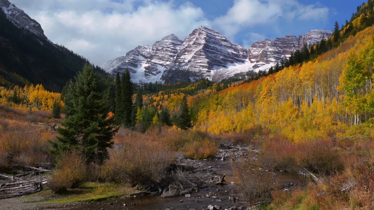 Maroon Creek River Maroon Bells 14er peak Colorado most photographed panoramic nature landscape fall autumn snow on top of Rocky Mountains White River Forest Aspen Snowmass Yellow Aspens Tree clouds
