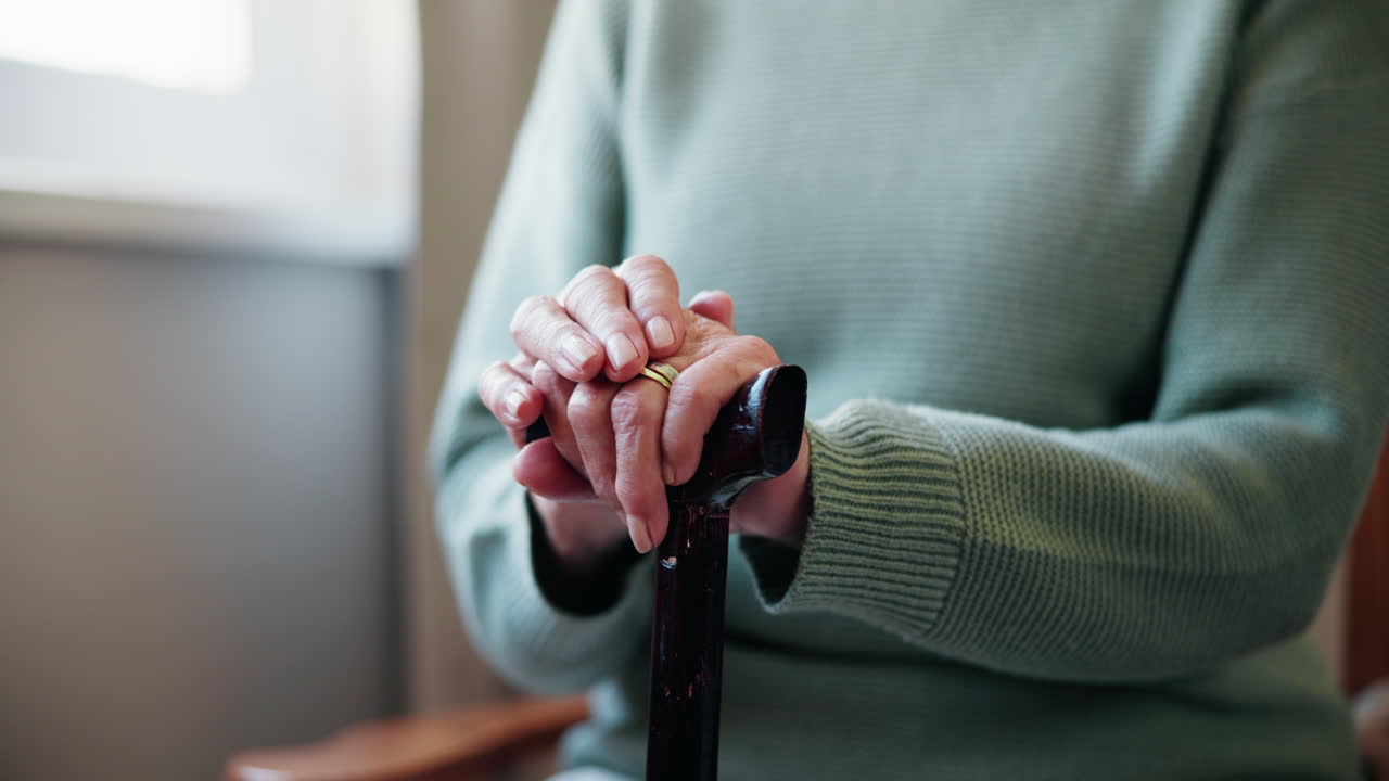 Elderly woman holding a walking cane