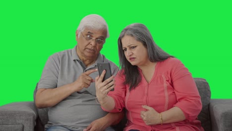 Angry-Old-Indian-couple-shouting-on-video-call-Green-screen