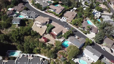 aerial view of upscale suburban neighborhood with swimming pools