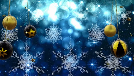 swinging black and gold christmas baubles over snowflakes and blue bokeh lights