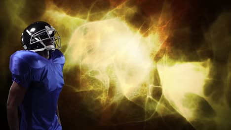 american football player holding helmet over light trails