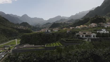 Drone-shot-showing-small-city-surrounded-with-mountains