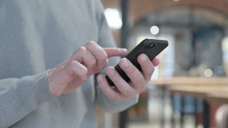 hands of man using smartphone