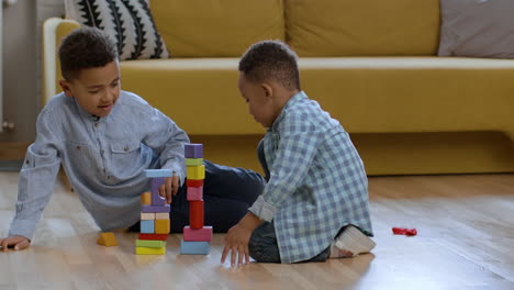 two boys playing with building blocks