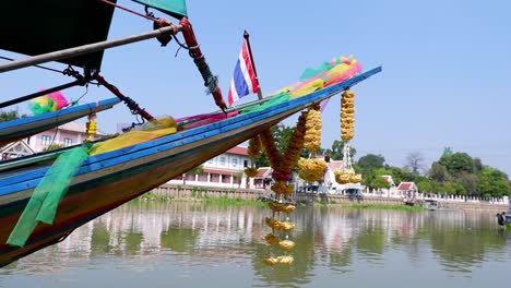 decorated boat moving along a serene river