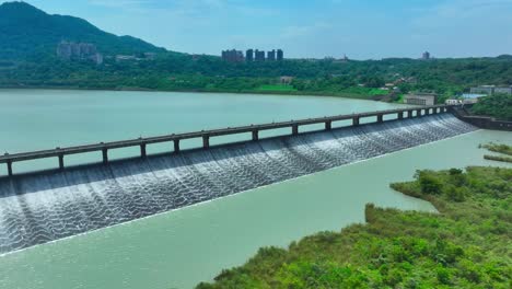 aerial approaching shot of dam and lake in taiwan during sunny day