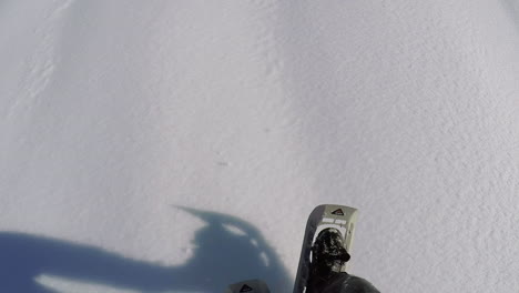 a winter hiker snowshoeing up into the snow covered hills and mountains of kodiak island alaska