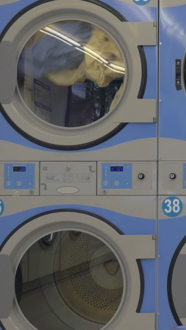 Clothes Tumbling in a Washing Machine at a Laundromat