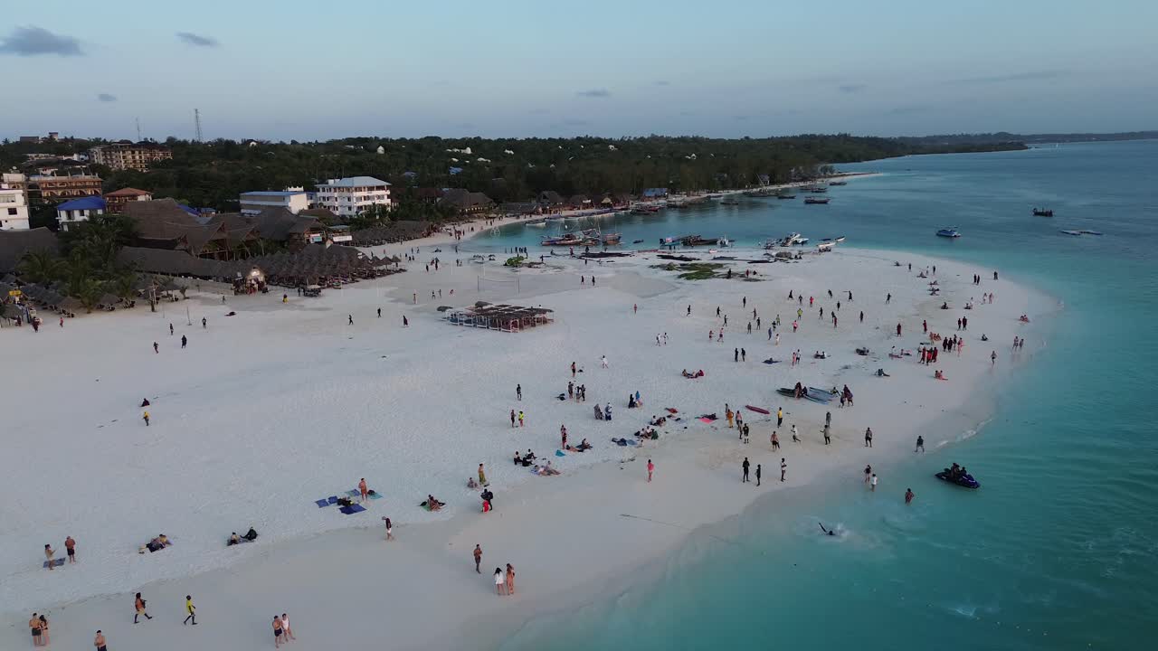 Aerial View of a Crowded Tropical Beach at Sunset