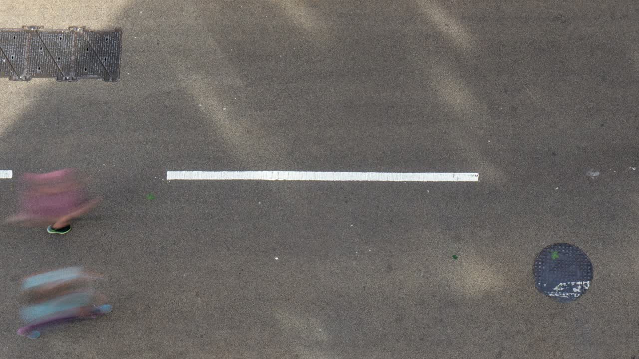 포장된 거리를 달리는 마라톤 선수들의 공중 저속 촬영