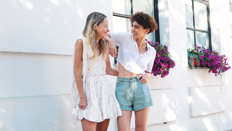 two women friends laughing outdoors