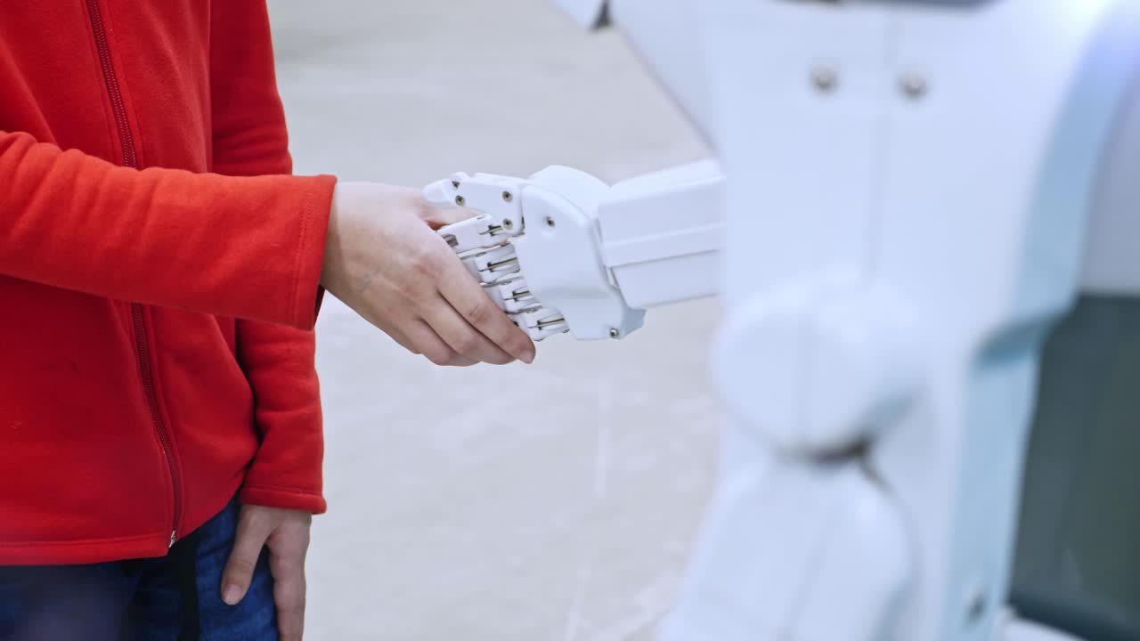 Person shaking hands with a robot