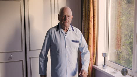 elderly man exercising with weights in bedroom