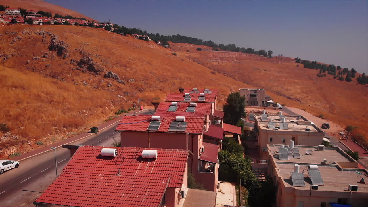 Small town with red rooftops in the desert Heat Aerial